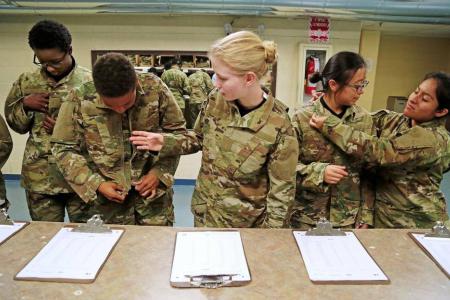 Jamie Udet, 18, middle, of Myrtle Beach, joins other recruits as they try on their uniforms for the first time, Thursday, June 30, 2016. Soldiers-in-training do all their in-processing in the reception stage, which includes paperwork, medical/dental screenings, shots and haircuts. They are also issued their uniforms and dogtags and begin their orientation in Army procedures & values. Gerry Melendez gmelendez@thestate.com