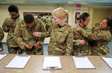 Jamie Udet, 18, middle, of Myrtle Beach, joins other recruits as they try on their uniforms for the first time, Thursday, June 30, 2016. Soldiers-in-training do all their in-processing in the reception stage, which includes paperwork, medical/dental screenings, shots and haircuts. They are also issued their uniforms and dogtags and begin their orientation in Army procedures & values. Gerry Melendez gmelendez@thestate.com